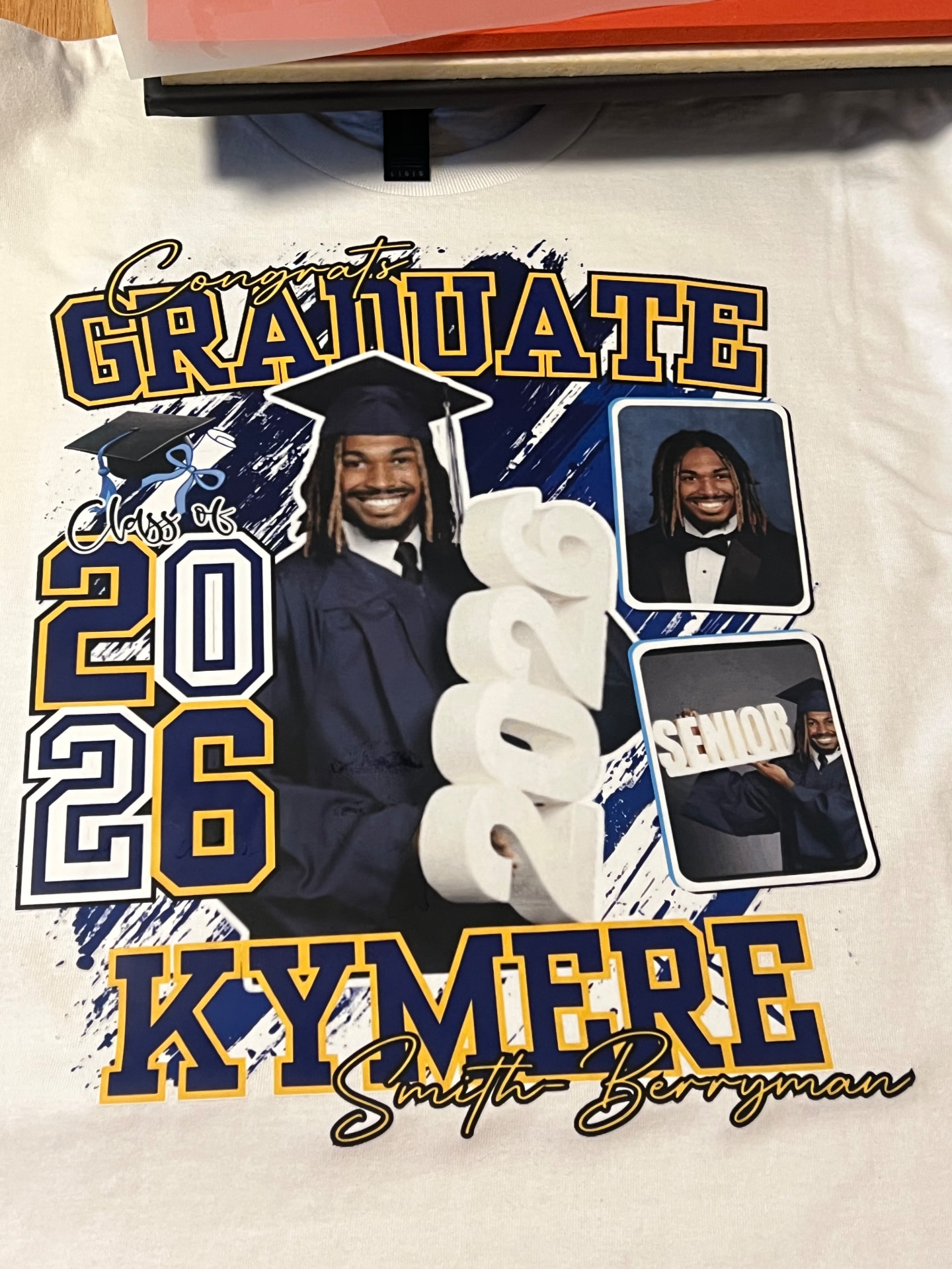 White shirt with a Class of 2026 graduate photo collage design fresh off the heat press